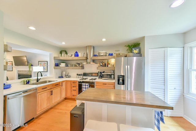 875 Martin Luther King Jr Blvd Apt 7, Chapel Hill, NC 27514 - kitchen featuring stainless steel appliances, light brown cabinetry, open shelves, island exhaust hood, and light wood-style flooring