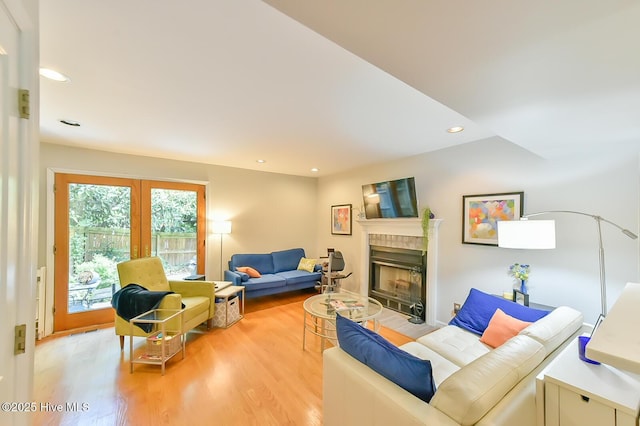 875 Martin Luther King Jr Blvd Apt 7, Chapel Hill, NC 27514 - living room featuring a tiled fireplace, light wood-type flooring, french doors, and recessed lighting