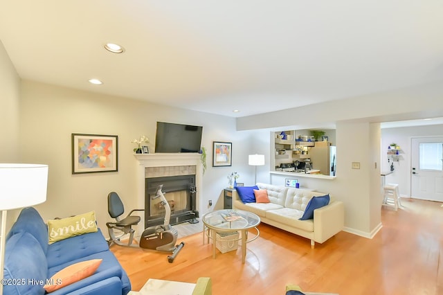 875 Martin Luther King Jr Blvd Apt 7, Chapel Hill, NC 27514 - living room featuring wood finished floors, a tiled fireplace, and recessed lighting