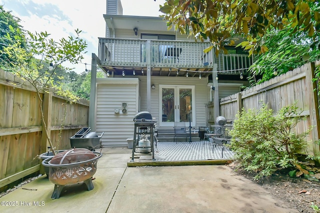 875 Martin Luther King Jr Blvd Apt 7, Chapel Hill, NC 27514 - back of property featuring a balcony, a fire pit, a fenced backyard, french doors, and a patio area