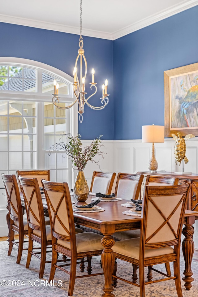 1119 Sea Bourne Way, Sunset Beach, NC 28468 - dining space with a chandelier, crown molding, a decorative wall, and wainscoting