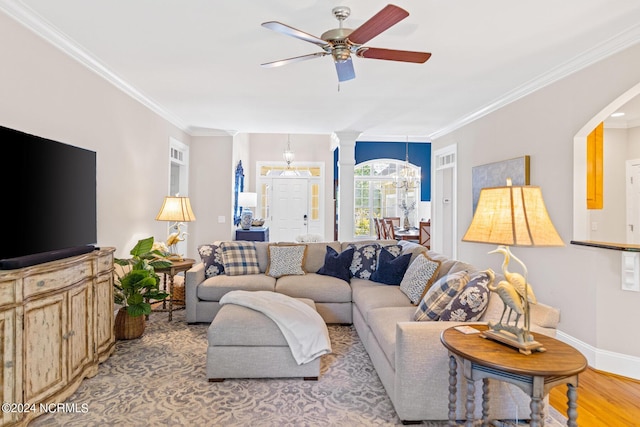 1119 Sea Bourne Way, Sunset Beach, NC 28468 - living area with ornamental molding, ceiling fan, a chandelier, arched walkways, and light wood-type flooring