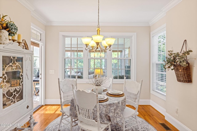1119 Sea Bourne Way, Sunset Beach, NC 28468 - dining space with a chandelier, light wood-style flooring, and crown molding