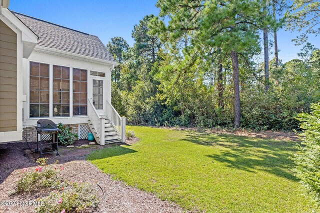 1119 Sea Bourne Way, Sunset Beach, NC 28468 - view of grassy yard with a sunroom