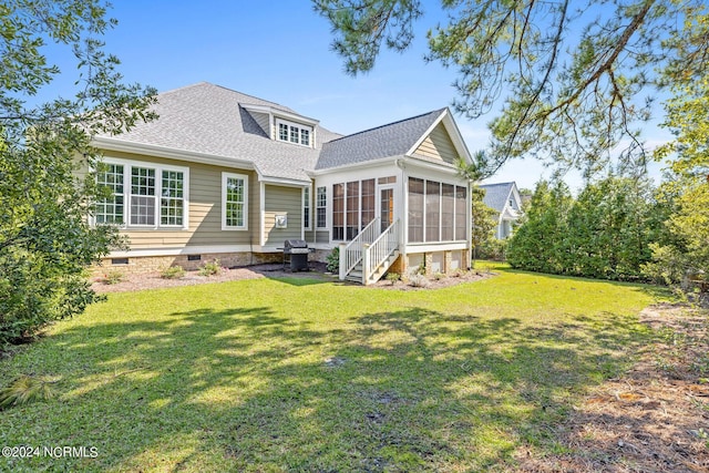 1119 Sea Bourne Way, Sunset Beach, NC 28468 - rear view of house with crawl space, a sunroom, a shingled roof, and a lawn