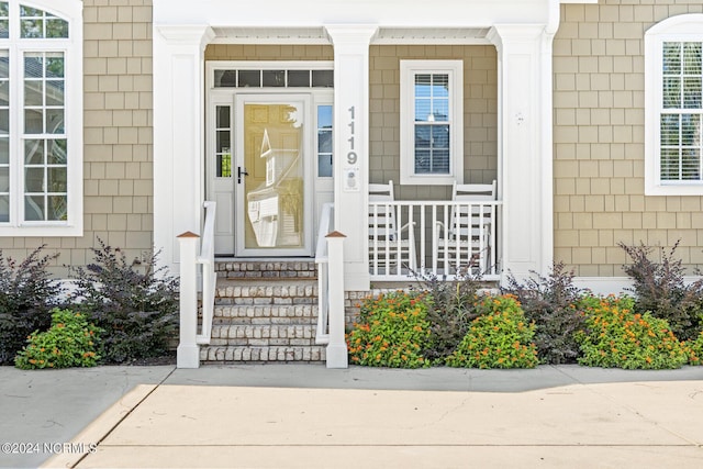 1119 Sea Bourne Way, Sunset Beach, NC 28468 - doorway to property featuring covered porch