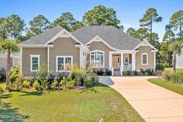 1119 Sea Bourne Way, Sunset Beach, NC 28468 - craftsman inspired home with a front lawn and a shingled roof