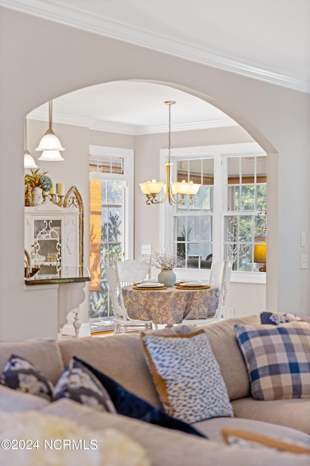 1119 Sea Bourne Way, Sunset Beach, NC 28468 - living room with crown molding, a chandelier, and arched walkways