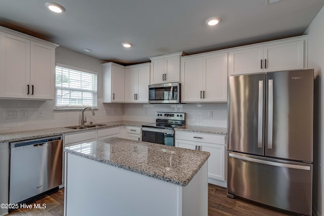 411 Isabelle St, New Bern, NC 28560 - kitchen featuring stainless steel appliances, white cabinets, a center island, decorative backsplash, and recessed lighting