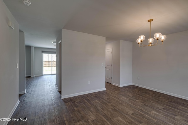 411 Isabelle St, New Bern, NC 28560 - spare room featuring dark wood finished floors, a smoke detector, and a chandelier