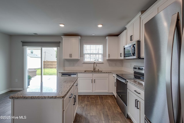411 Isabelle St, New Bern, NC 28560 - kitchen with stainless steel appliances, dark wood finished floors, backsplash, white cabinetry, and recessed lighting