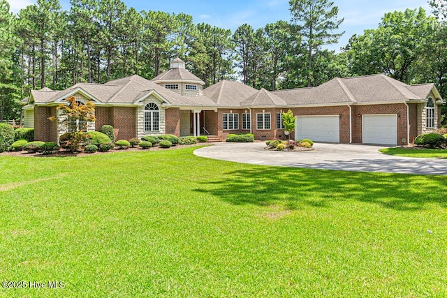 35 Magnolia Ave, Pinehurst, NC 28374 - view of front of house with driveway, an attached garage, a front lawn, and brick siding