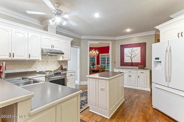 35 Magnolia Ave, Pinehurst, NC 28374 - kitchen featuring white fridge with ice dispenser, gas range, under cabinet range hood, a kitchen island, and dark wood-style flooring
