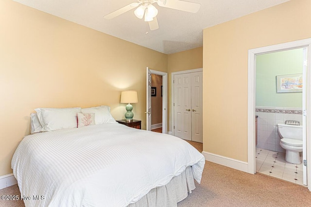 35 Magnolia Ave, Pinehurst, NC 28374 - carpeted bedroom featuring a closet, ensuite bath, ceiling fan, and tile patterned flooring