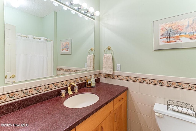 35 Magnolia Ave, Pinehurst, NC 28374 - full bath with vanity, wainscoting, and tile walls