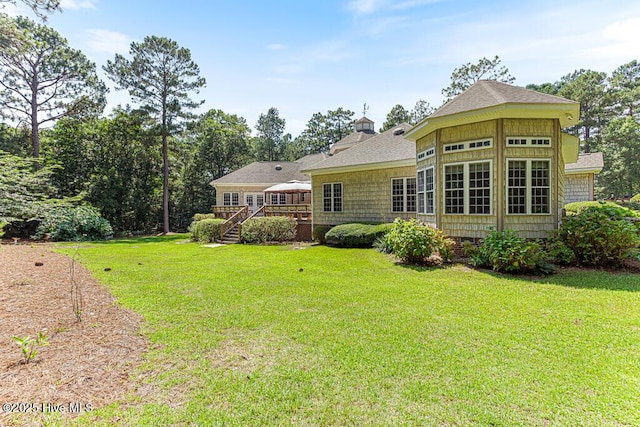 35 Magnolia Ave, Pinehurst, NC 28374 - rear view of house featuring a deck, stairs, a lawn, and a shingled roof