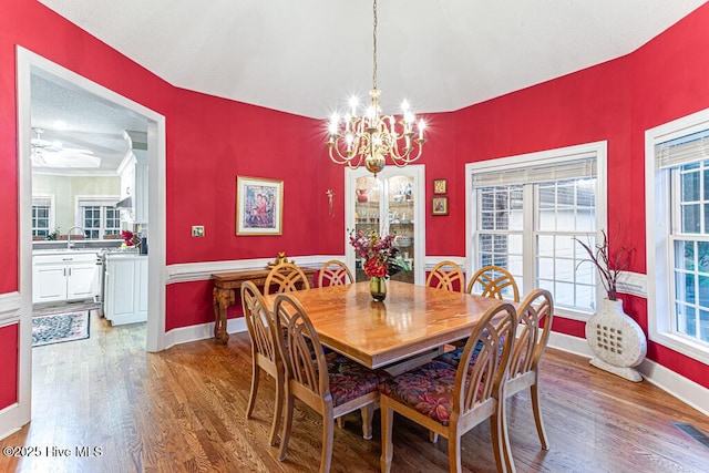 35 Magnolia Ave, Pinehurst, NC 28374 - dining space featuring a chandelier, wood finished floors, and healthy amount of natural light