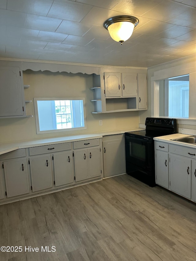 4735 Cedar Ln SW, Ocean Isle Beach, NC 28469 - kitchen with black electric range oven, open shelves, light wood-type flooring, and light countertops