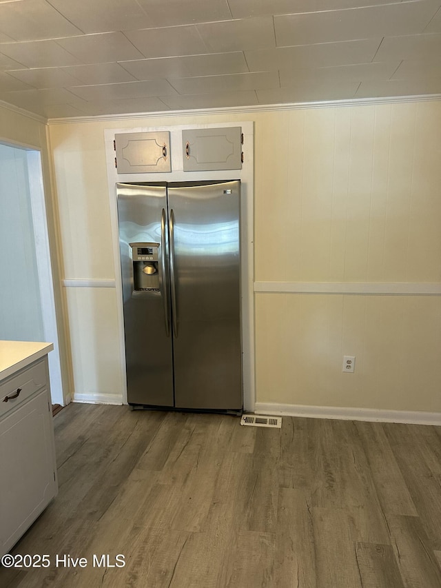 4735 Cedar Ln SW, Ocean Isle Beach, NC 28469 - kitchen with stainless steel fridge with ice dispenser, wood finished floors, and light countertops