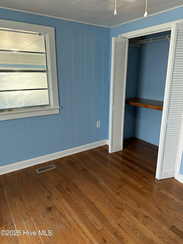 4735 Cedar Ln SW, Ocean Isle Beach, NC 28469 - unfurnished bedroom with wood finished floors and a closet