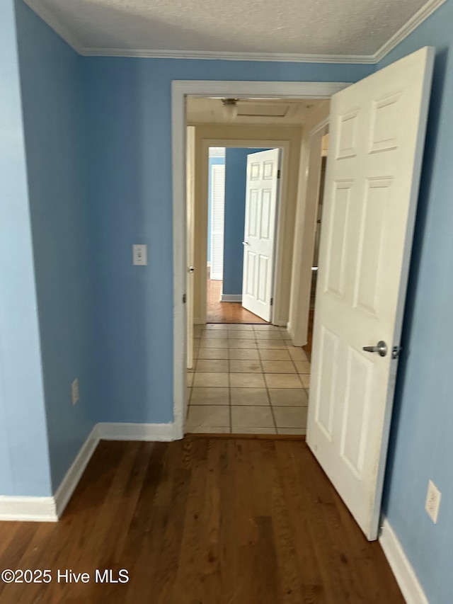 4735 Cedar Ln SW, Ocean Isle Beach, NC 28469 - hall with dark wood-type flooring, crown molding, and a textured ceiling