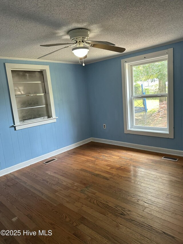 4735 Cedar Ln SW, Ocean Isle Beach, NC 28469 - spare room with hardwood / wood-style flooring, ceiling fan, and a textured ceiling