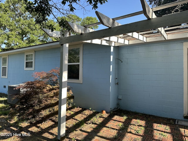 4735 Cedar Ln SW, Ocean Isle Beach, NC 28469 - view of side of property featuring concrete block siding and a pergola