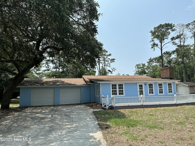 4735 Cedar Ln SW, Ocean Isle Beach, NC 28469 - ranch-style house featuring driveway, an attached garage, and a chimney