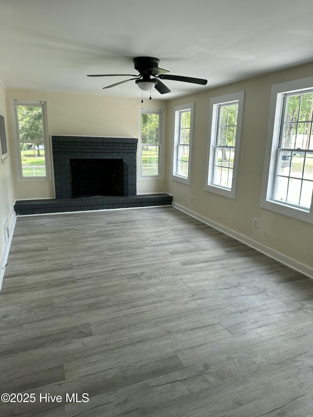 4735 Cedar Ln SW, Ocean Isle Beach, NC 28469 - unfurnished living room with wood finished floors, a brick fireplace, and a ceiling fan