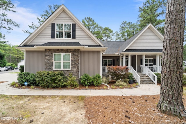 1 Miles Ct, Pinehurst, NC 28374 - view of front facade featuring stone siding, a porch, and roof with shingles