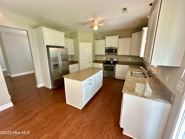 802 Bayhill Ct, Greenville, NC 27858 - kitchen featuring appliances with stainless steel finishes, a center island, a ceiling fan, white cabinets, and light stone counters