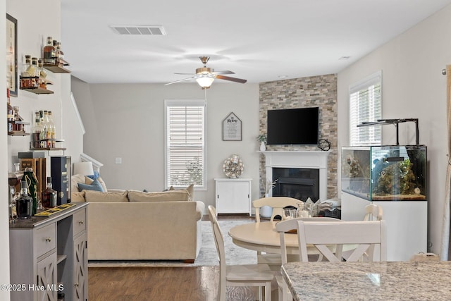 3243 Kellerton Pl, Wilmington, NC 28409 - living area with a ceiling fan, a large fireplace, and dark wood-style flooring