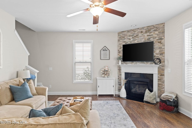 3243 Kellerton Pl, Wilmington, NC 28409 - living room with ceiling fan, a large fireplace, dark wood-style floors, and stairs