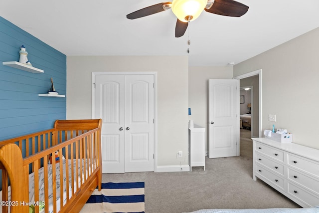 3243 Kellerton Pl, Wilmington, NC 28409 - bedroom with a closet, carpet floors, wood walls, ceiling fan, and a crib