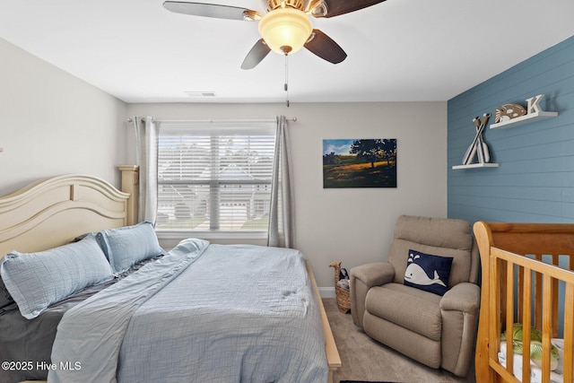 3243 Kellerton Pl, Wilmington, NC 28409 - bedroom featuring wood walls, ceiling fan, and carpet flooring