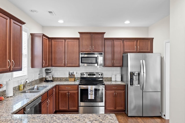 3243 Kellerton Pl, Wilmington, NC 28409 - kitchen with stainless steel appliances, light stone counters, plenty of natural light, and wood finished floors
