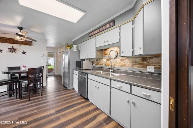 304 N Main St, Colerain, NC 27924 - kitchen featuring stainless steel appliances, dark countertops, decorative backsplash, dark wood-style flooring, and ornamental molding