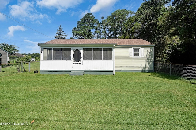 1311 Hazel Ave, New Bern, NC 28560 - view of front of home with a sunroom, a fenced backyard, and a shingled roof