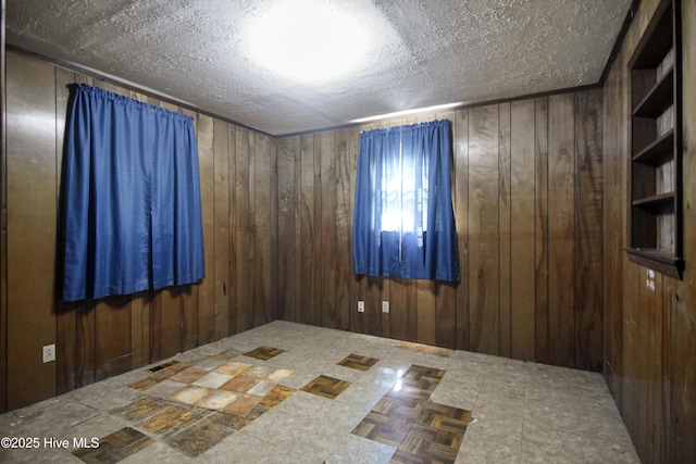 1311 Hazel Ave, New Bern, NC 28560 - empty room with wooden walls and a textured ceiling