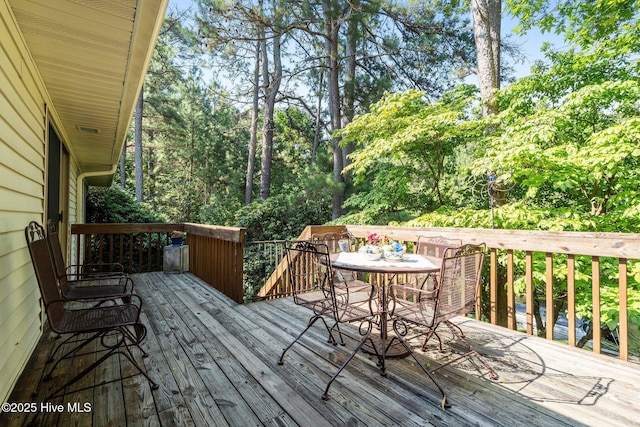 115 Baker Cir W, End, NC 27376 - wooden terrace featuring outdoor dining area and view of wooded area