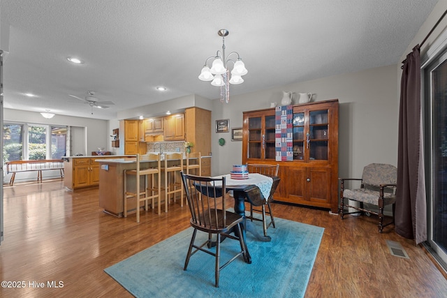 115 Baker Cir W, End, NC 27376 - dining area with dark wood-style floors, recessed lighting, a ceiling fan, a textured ceiling, and a chandelier