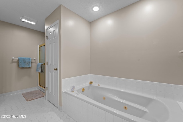 115 Baker Cir W, End, NC 27376 - full bathroom featuring a jetted tub, a shower stall, and tile patterned floors