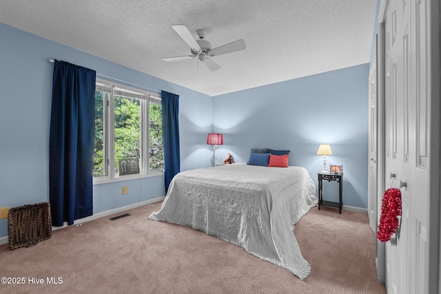 115 Baker Cir W, End, NC 27376 - carpeted bedroom with a textured ceiling and a ceiling fan