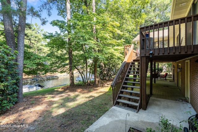 115 Baker Cir W, End, NC 27376 - view of yard with stairway, a deck with water view, and a patio