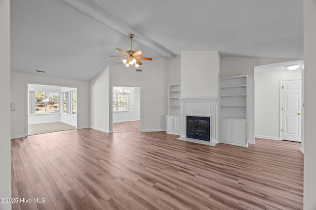 108 Bayswater Ct, New Bern, NC 28562 - unfurnished living room featuring wood finished floors, ceiling fan, a fireplace with flush hearth, and a chandelier