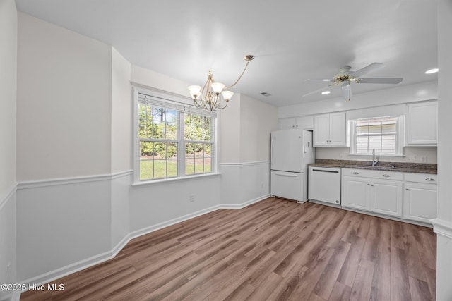 108 Bayswater Ct, New Bern, NC 28562 - kitchen with white appliances, white cabinets, light wood-type flooring, a chandelier, and recessed lighting