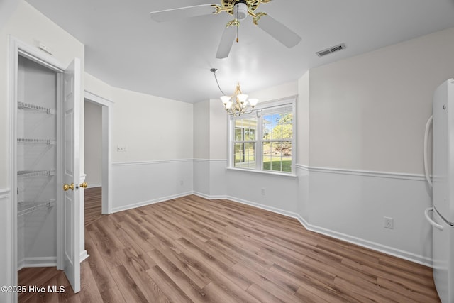 108 Bayswater Ct, New Bern, NC 28562 - spare room with wood finished floors, a ceiling fan, and a chandelier