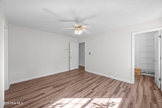 108 Bayswater Ct, New Bern, NC 28562 - unfurnished bedroom featuring wood finished floors, a closet, ceiling fan, and a spacious closet