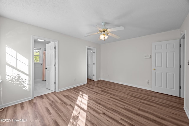 108 Bayswater Ct, New Bern, NC 28562 - unfurnished bedroom featuring wood finished floors, a textured ceiling, and a ceiling fan