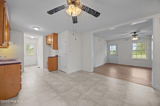 1218 Early Station Rd, Aulander, NC 27805 - kitchen featuring ceiling fan, brown cabinets, light floors, and open floor plan